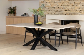 travertine-top-dining-table-black-star-base-lifestyle