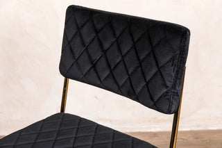 black chair gold legs