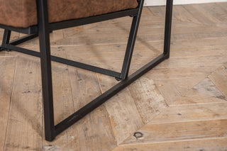 brown leather armchair with metal frame