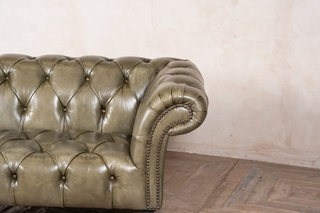 button back green sofa