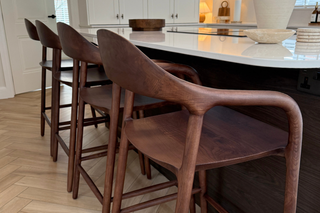 Wooden bar stools in a modern kitchen setting