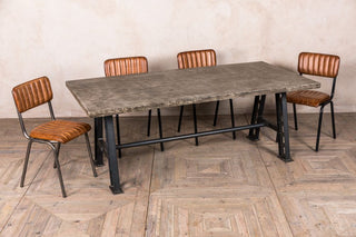 concrete-look-table-with-a-frame-base-and-arlington-chairs