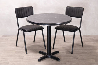 alcantara-black-round-top-with-x-bottom-base-and-chairs