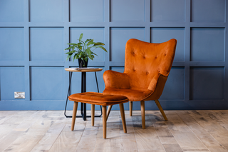 orange lounge chair and footstool