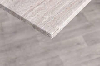 travertine-top-gunmetal-star-based-dining-table-corner