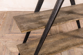 wooden X-frame bookshelf