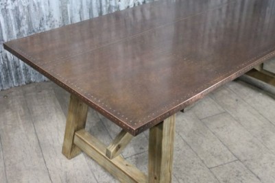 copper dining table with studwork