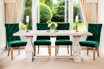 traditional whitewashed dining table and dark green chairs