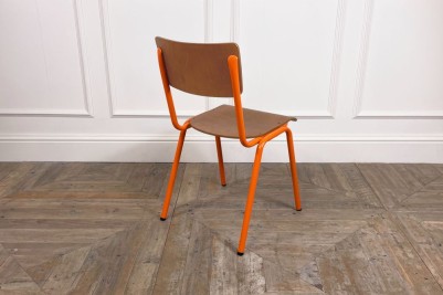 orange stacking chair with metal frame
