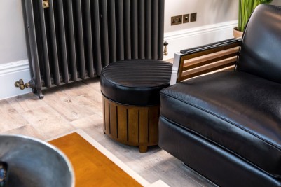 black-leather-pouf-seat-in-home