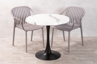 white-marble-table-with-dark-grey-california-chairs