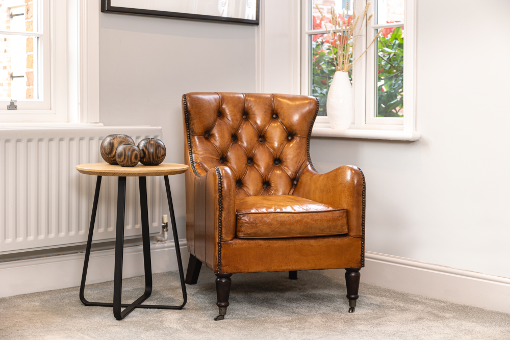 tan leather button back armchair